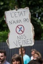 People protesting in the street against the cover-19 vaccine with banner in french, letat n aura pas nos veines, in english, the g