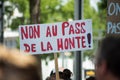 people protesting in the street against the sanitary pass, with banner in french, non au pass de la honte, in english , no pass o
