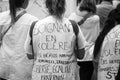 portrait on back view of women protesting in the street with text on shirt in french, soignant en colÃÂ¨re, in English, angry care