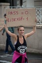 Girl protesting in the street against the sanitary pass with banner in french : Pass = 0, Liberte = 1, traduction in english : Pas