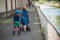 Portrait of woman with children in roller skate with protection in border channel