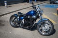 Profile view of blue Yamaha virago motorbike parked in the street Royalty Free Stock Photo