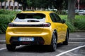 Rear view of yellow Peugeot 208 gt line parked in the street