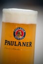 Glass of french beer from Paulaner` brand at restaurant terrace