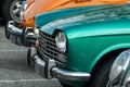 Closeup of green Peugeot 204 parked in vintage exhibition cars