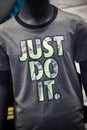 Just do it logo by nike compagny on grey teeshirt in a fashion store showroom