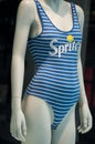 Sprite logo on blue stripped swimsuit on mannequin  in fashon store showroom Royalty Free Stock Photo