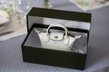 white mini handbag by Longchamp in a luxury carton box on a table