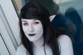 Portrait of sexy girl with dracula teeth and pointed ears at the geek cosplay convention