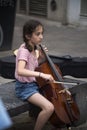 Portrait of young girl playing cello in the street Royalty Free Stock Photo