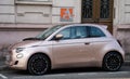 Profile view of beige new Fiat 500 parked in the street Royalty Free Stock Photo