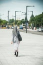 Veiled Muslim woman walking in the street near the train station