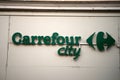 closeup of carrefour city signage on store front in the street