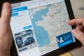 Closeup of woman hands on home page of the Michelin map route web site on tablet