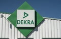 Dekra logo on store front on blue sky background