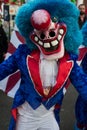 portrait of colorful masked people parading in the street