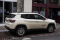 Profile view of beige Jeep compass parked in the street