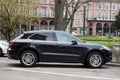 Profile view of black Porsche Macan SUV car parked in the street