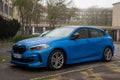 Profile view of blue BMW M1 series parked in the street Royalty Free Stock Photo