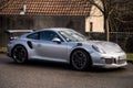 Profile view of grey Porsche 911 GT3 rs parked in the street