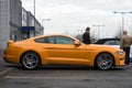 Profile view of orange and white ford mustang 500 GT cars parked in the street Royalty Free Stock Photo