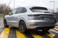 Rear view of grey Porsche cayenne parked in the street by rainy day