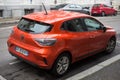 rear view of new orange Renault Clio parked in the street