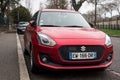 rear view of orange suzuki swift sport parked in the street