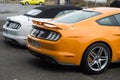 rear view of orange and white ford mustang 500 GT cars parked in the street Royalty Free Stock Photo