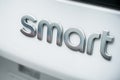 Smart logo sign on white car rear
