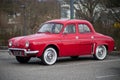 Profile view of red Renault Dauphine vintage parked in the street