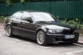 Front view of black BMW 330d parked in the street