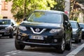 Front view of black Nissan X-trail parked in the street