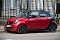 front view of red and black smart car parked in the street Royalty Free Stock Photo