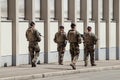 Military mens patroling in the street whit shotguns