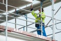 Portrait of worker on scaffold on construction site of concrete building Royalty Free Stock Photo