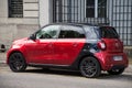 Rear view of red and black smart car parked in the street Royalty Free Stock Photo