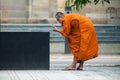 tibetan monk taking a picture of fountain on a place