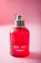 Amor Amor perfume from Cacharel brand in red bottle on pink background