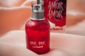 Amor Amor perfume from cacharel brand in red bottle on satin background Royalty Free Stock Photo