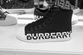 black sneakers by Burberry in a luxury fashin store showroom