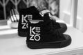 black sneakers by Kenzo in a luxury fashin store showroom