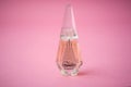 Givenchy ange ou demon perfume in a miniature bottle on pink background