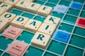 Plastic letters to forming  crosswords on Scrabble board game Royalty Free Stock Photo