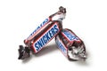 Snickers chocolate bar by Mars compagny in brown packaging on white background