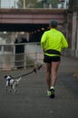 portrait of man running with his dog in border channel