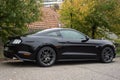Profile view of black ford mustang 500 GT cars parked in the street Royalty Free Stock Photo