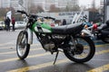 Profile view of green Yamaha motorbike 125CC parked in the street