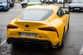 Rear view of yellow Toyota Supra parked in the street