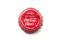 Drops of water on Cocacola capsule on white background on top view